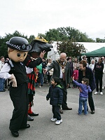 Connie, the community policeman, and  the Morris dancer's horse meet the public.